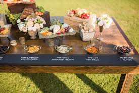 Food bars are a great way to add a personal touch to your reception space and give a little nod to your wedding theme at the same time. Wedding Decor Rustic Farm Table Dining Metallic Accents Exquisite Weddings