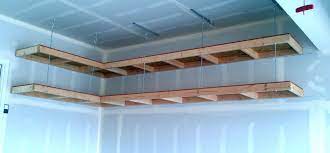 Our garage isn't very wide, but has 10.5' ceilings. Which Is A Better Overhead Garage Storage System For You A Shelf Is Good But Generally You W Diy Overhead Garage Storage Wooden Garage Shelves Garage Storage