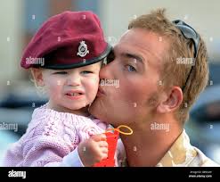Lance Bombardier Martin Cartwright kisses his 18-month-old daughter Faye  after his return to Merville Barracks in Colchester, following a tour of  duty in Afghanistan Stock Photo