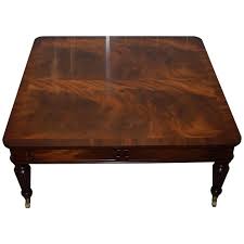 This item item is shipped via our white glove service, in which the merchandise is brought into your home or office. Square Flamed Mahogany Coffee Table Carbed Legs Castors With Drawers At 1stdibs
