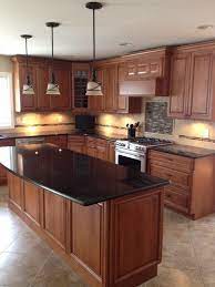 The light blue cabinets and black countertops create a contrast that's contemporary but not too mainstream, leaving you a little room for individuality in your kitchen. 23 Best Medium Brown Cabinets Dark Brown Countertop Ideas Kitchen Remodel Kitchen Design Kitchen Countertops