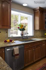 Kitchen Remodel By Renovisions Decorative Tan And Black Tile Backsplash Granite Countertops With Mat Kitchen Window Sill Kitchen Remodel Kitchen Interior Diy