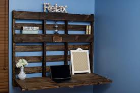 The perfect petite workspace for a small home or apartment, this chic diy desk drops down lay the decorative panels out on your 36 x 24 x 3/4 piece of wood (which will be the desk's door) to create your preferred design before gluing them down. Diy Pallet Wall Folding Desk Pallet Furniture Plans