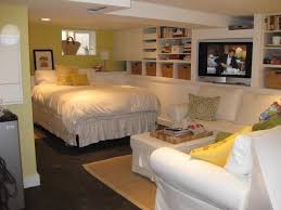 Neutral basement features a sectional and wood accents. Basement Beauties How To Spruce Up The Dungeon Downstairs Basement Guest Rooms Basement Master Bedroom Cheap Basement Ideas