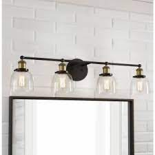 This piece was inspired by the idea of a beautiful chest of drawers as a bathroom vanity, whether that's in a warm wood finish or a crisp painted one. Home Decorators Collection Evelyn 4 Light Artisan Bronze Vanity Light Hb2628 313 The Home Depot Bronze Vanity Lighting Black And Gold Bathroom Black Bathroom Light