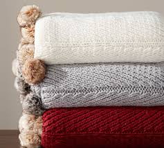 Make a blanket inspired by this pottery barn throw, also pictured above on the left. Faux Fur Pom Pom Knitted Throw Blanket Pottery Barn