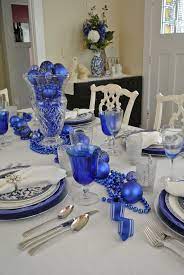 A solid background—such as a blue table runner—will make these decorations pop. Blue Christmas Decorations Christmas Celebration All About Christmas Blue Christmas Decor Christmas Tree Ideas With Colored Lights Christmas Table Decorations