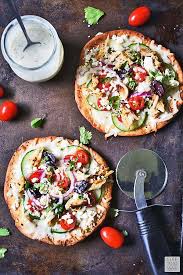 Greek Pita Pizza Is Seasoned Pita Bread Topped With All Of Your Favorite Greek Flavors Serve This Individual Greek Pizza Wi Greek Pita Pita Pizzas Greek Pizza