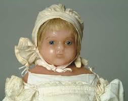 An English wax head baby doll signed Lucy Peck; <i>image courtesy of James  D. Julia Auctions</i>.