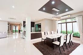 Woman in white living room with armchair. Top 25 Porcelain Tiles Tilesporcelain