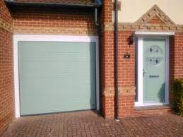 Many companies these days are manufacturing with an eye towards the green movement. Endurance Door Kyo Chartwell Green With Matching Ryterna Sectional Garage Door Garage Door Design Green Front Doors Chartwell Green Front Door