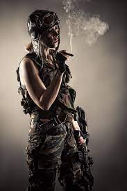 Woman In Uniform With Guns Rests Smoking Cigar Stock Photo Download Image Now Istock