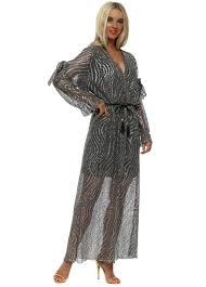 Metallic bronze knit maxi dress with crochet trim, long sleeves and a matching sash by wenjilli. Black Gold Metallic Knit Maxi Dress