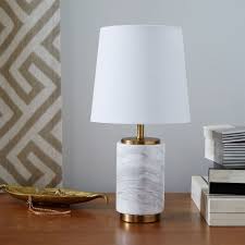 Inspired by classic european table lamps, this table lamp boasts a contemporary twist by adding a white marble base, which goes perfectly with the brass construction. Pillar Marble Table Lamp