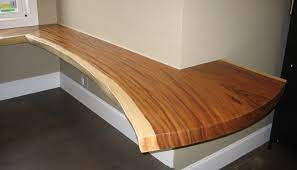 The wood's natural graining provides texture and character, while the live edge boasts rustic charm. Live Edge Desks Lanterman Woodworks