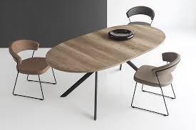 Fixed central metal base with four elliptical sloping legs and book leaf opening with central leaf in the same color as the base. Giove Extendable Dining Table Innoconcept