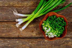 Top view of ripe green onions at georgian market. What Are Scallions And How Are They Used