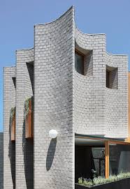 The Fluted Facade Is Informed By The Ridges On A Prawn S Shell And Is Clad In Brickwork With Grey And Green Brick Architecture Architecture Facade Architecture
