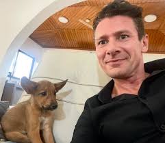 His smile says it all. He is one happy puppy, now that he has someone to  love & love him