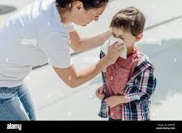 Mother blowing a nose of her upset son Stock Photo - Alamy