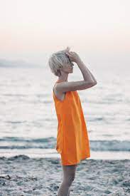 My short hair tutorial is now live on the blog {link in bio!} the perfect read if you're thinking about rocking a lob.blonde beach waves for short hair #beachwaves #shorthair #hairstyles #bobhaircut #blondehair everyone wants to get beach waves for short hair. Portrait Of A Blonde Short Hair Female Model In Orange Dress On The Beach At Sunset From Behind By Branislava Zivic