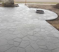 A strong concrete stamped patio consisting of an intricate herringbone pattern design. Concrete Color Options