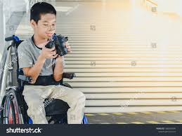 Photographer Child On Wheelchair Is Holding A Camera In Hand He Was Smiling And Having Fun With It Life In The Ed Photo Editing Photographer Disabled Children