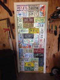 My Husband S Idea Of How To Display License Plates It Turned Out Really Cool License Plate Old License Plates License Plate Decor