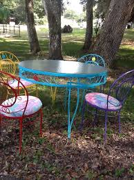 Wrought Iron Table And Chairs I Painted Different Colors I Used An Old Shower C Outdoor Tables And Chairs Wrought Iron Patio Furniture Outdoor Furniture Chairs