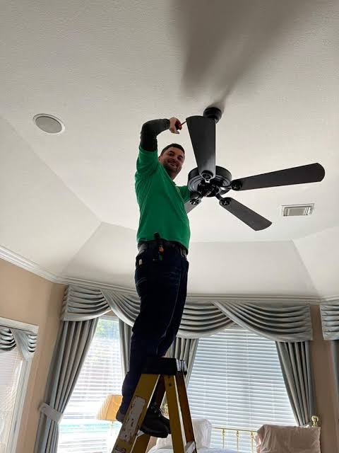 Fitter installing recessed spotlights in a Plumstead kitchen