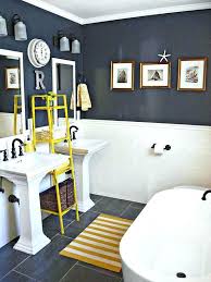 This navy and white bathroom uses a soft medium blue wallpaper on one of the walls and a darker navy for the vanity top. Navy Blue Bathroom Navy Blue Bathroom Ideas Navy Blue Bathroom Floor Yellow Bathrooms Bathroom Decor Freestanding Bathroom Storage