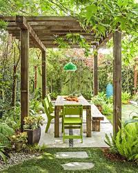 A Pergola Creates An Outdoor Room In The Backyard Complete With A Dining Table An Outdoor Pendant Light And Shade P Backyard Dining Pergola Backyard Pergola
