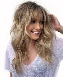 Pair your long waves with a thick fringe. 50 Cute Long Layered Haircuts With Bangs 2021