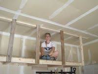The garage ceiling is a perfect place to store light and medium weight seasonal items like holiday decorations and camping gear. 33 Garage Ceiling Storage Ideas Garage Storage Garage Ceiling Storage Ceiling Storage