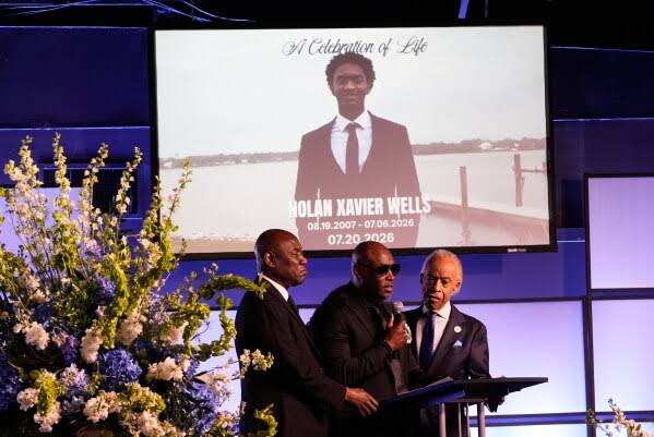 Ben Crump and two men speak at Nolan Xavier Wells celebration of life memorial podium