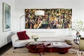 Yellow living room with a white fireplace and flat panel tv in between beige round back chairs. 27 Modern Living Rooms Full Of Luxurious Details Architectural Digest