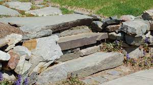 The design really depends on the type of material you're using, the gradient and the length of the slope. Comparing Stones Steps And Concrete Steps In Garden Construction