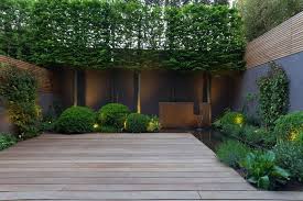 A Steel Water Feature Is Part Of A Small Pond That Wraps Around Two Sides Of The Patio And Adds To The Privacy Screen Outdoor Backyard Privacy Outdoor Privacy