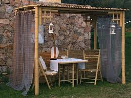 use bamboo poles with breezy fabric to create a sweetheart s table for your dream wedding bamboo pergola diy pergola outdoor pergola