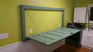 A Fold Up Table Made From An Old Door And Door Frame Laundry Table Door Desk Doors Repurposed