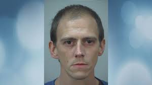 Man arrested for spitting at police, trying to attack health care workers,  police say