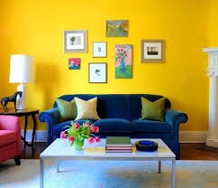 Minimalist Living Room Interior Decorating Ideas With Yellow Wall Paint Color And Blue Velvet Sofa Living Room Colors Colourful Living Room Yellow Living Room