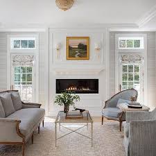 This living room idea revolves around the calming effect of light blue hues, both in terms of its wall color and in terms of its furniture choices. Modern French Living Rooms Design Ideas