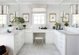 White bathroom with carrera marble counters, open towel storage. Traditional White Bathroom With Carrara Marble Vanity Tops Marble Floor