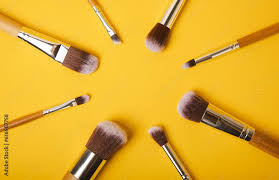 cosmetic makeup brush on yellow