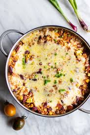a pan of cooked mexican quinoa topped with melted cheese