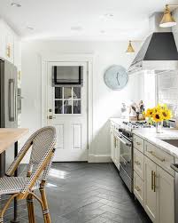 white and gold kitchen with black floor