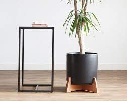 It is made of wood and iron. Reversible Plant Stand Medium Mid Century Modern Plant Stand With Ceramic Pot Wood Plant Stand Matte Pot Home Living Planters Pots
