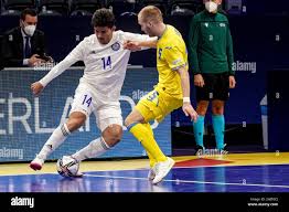 AMSTERDAM, NETHERLANDS - JANUARY 31: Douglas Junior of Kazakhstan, Yaroslav  Lebid of Ukraine during the Men's Futsal Euro 2022 Quarterfinals match  between Kazakhstan and the Ukraine at the Ziggo Dome on January
