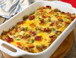 Eggs, sausage and hashbrowns are layered in a casserole dish, topped with cheese and baked to a gooey golden brown. Fully Loaded Cheesy Breakfast Casserole With Breakfast Sausage Bacon